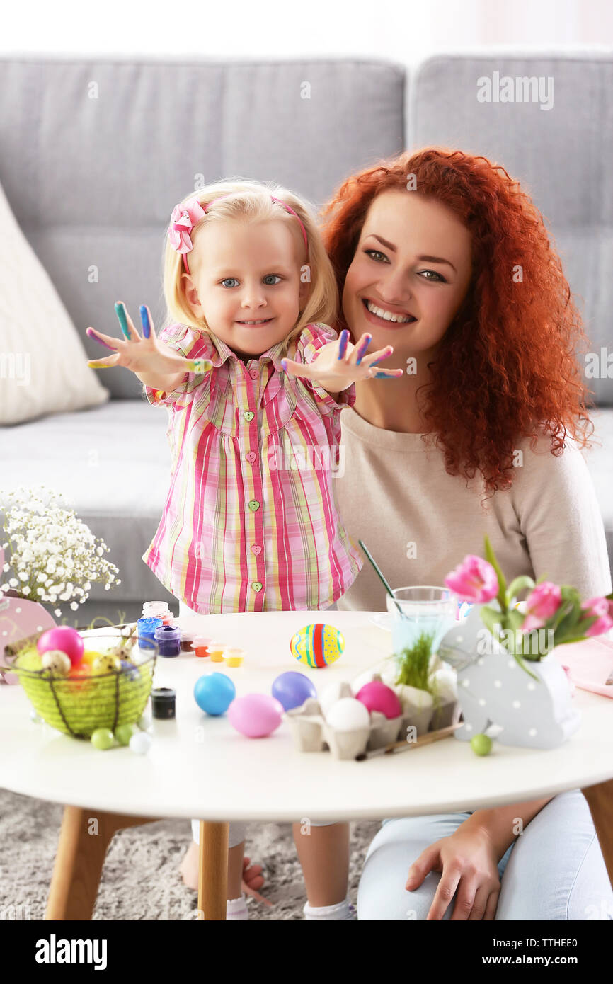 Mother and daughter decorating Easter eggs, indoors Stock Photo