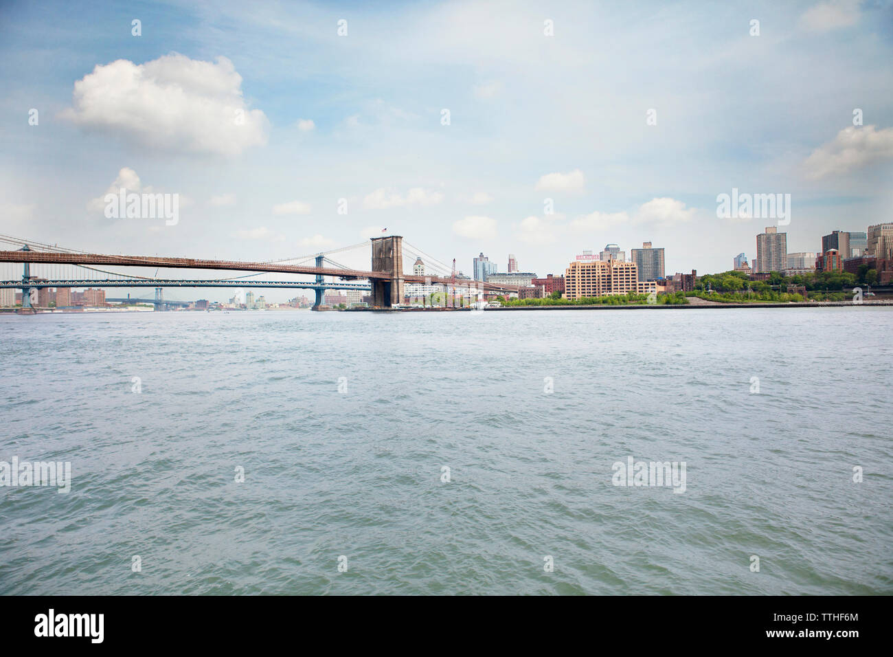 Bridges over East river in city against sky Stock Photo