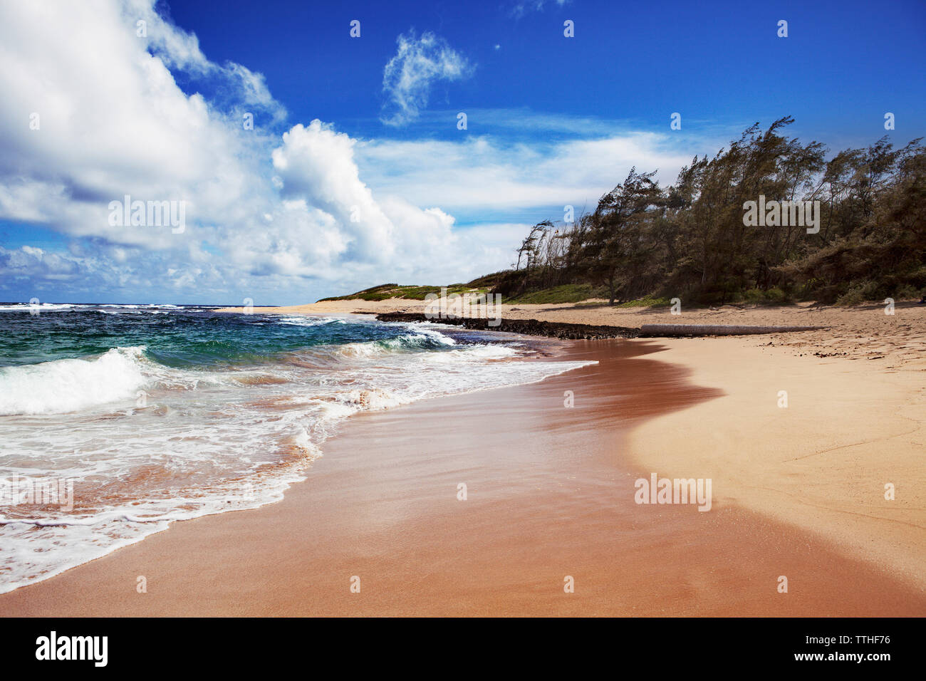 Idyllic view of sea waves rushing towards shore at beach against sky Stock Photo