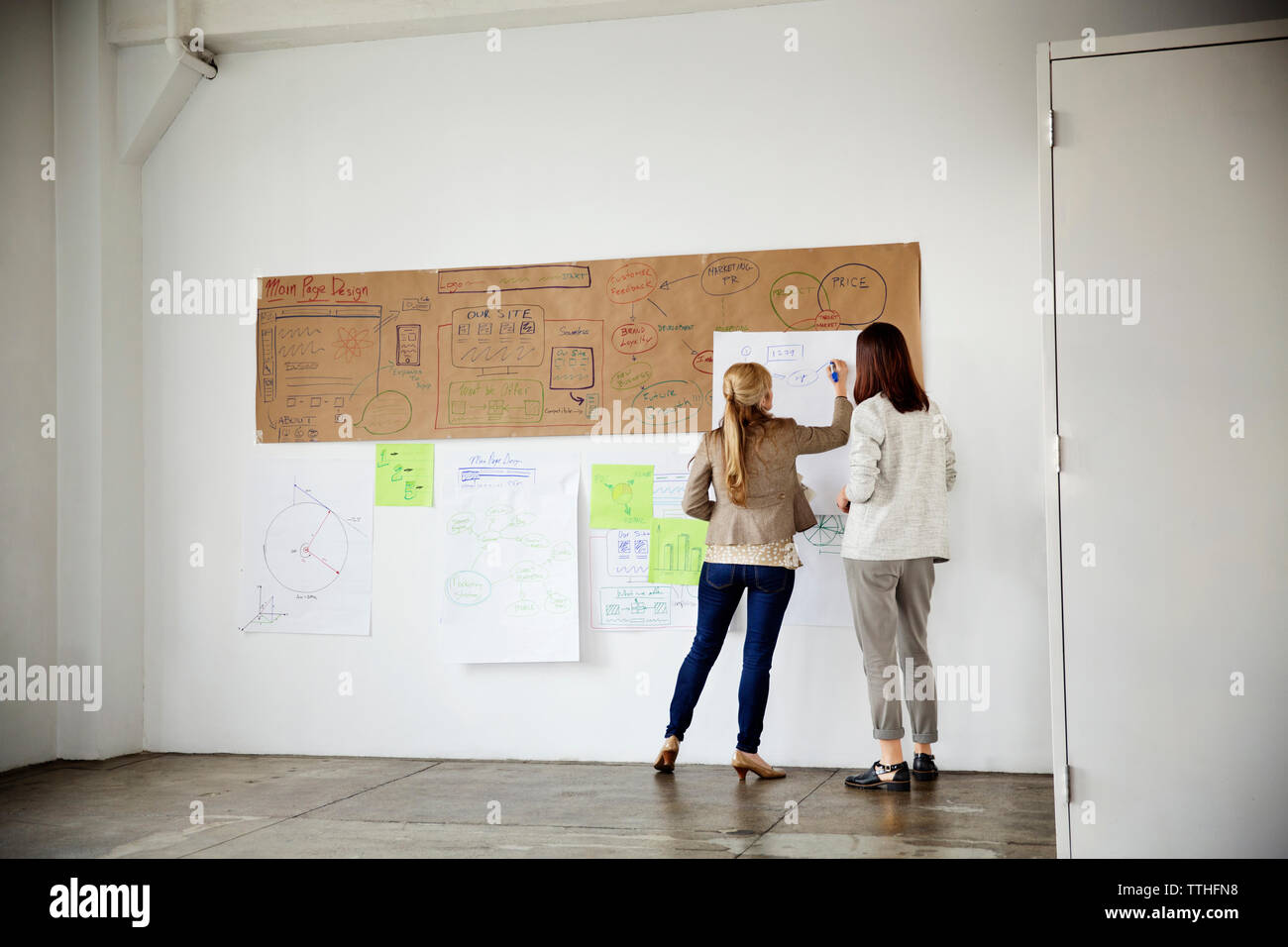 Rear view of businesswomen planning strategy in creative office Stock ...
