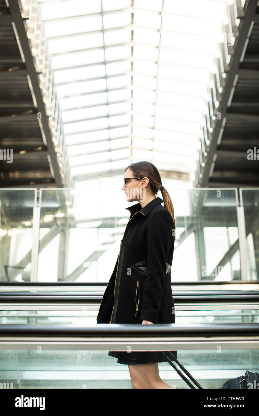 businesswoman with suitcase walking at railroad station Stock Photo