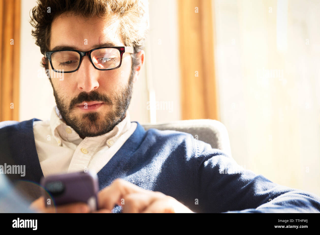 businessman using phone while sitting at home Stock Photo
