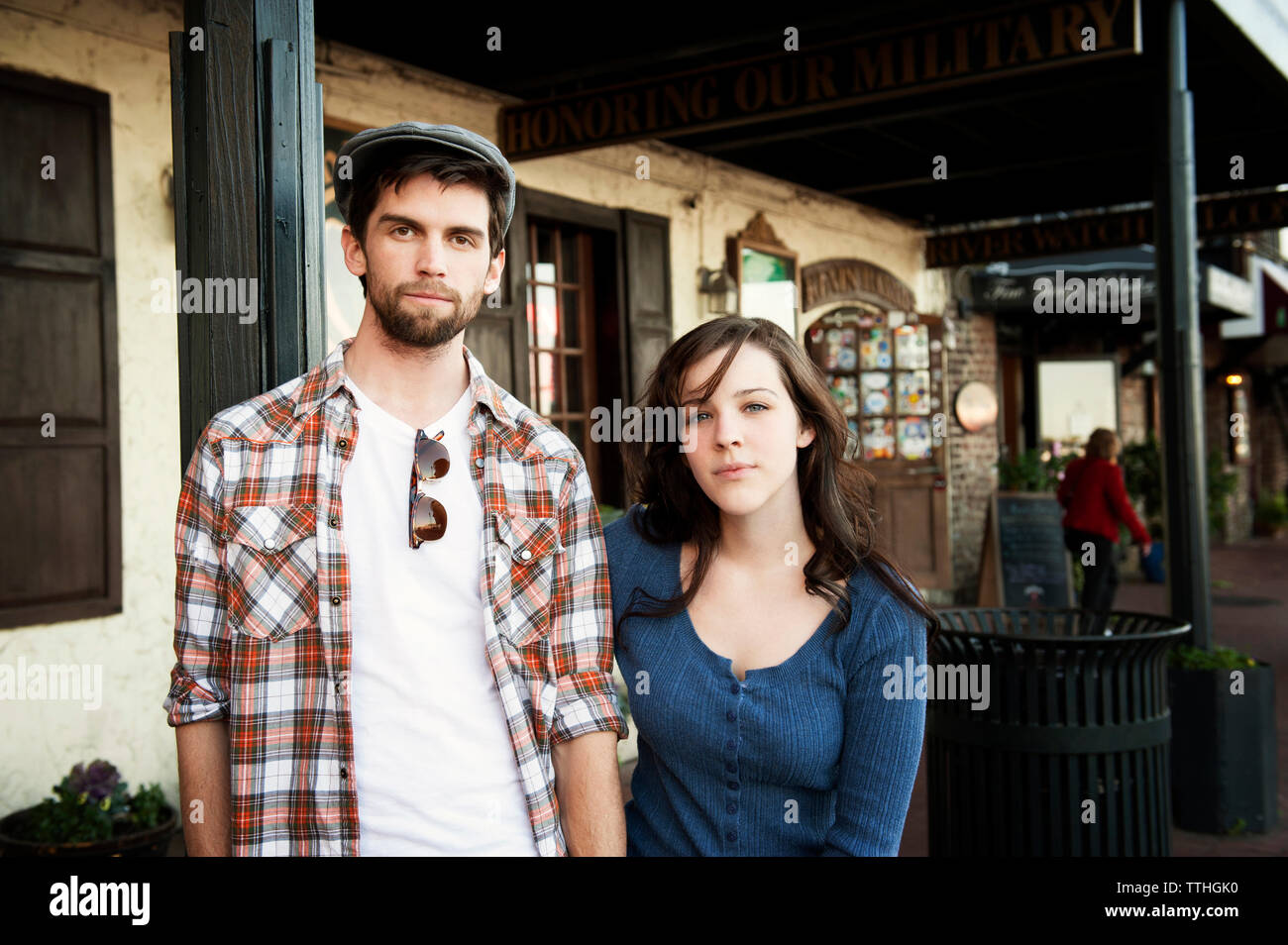 Portrait of couple standing against building Stock Photo - Alamy