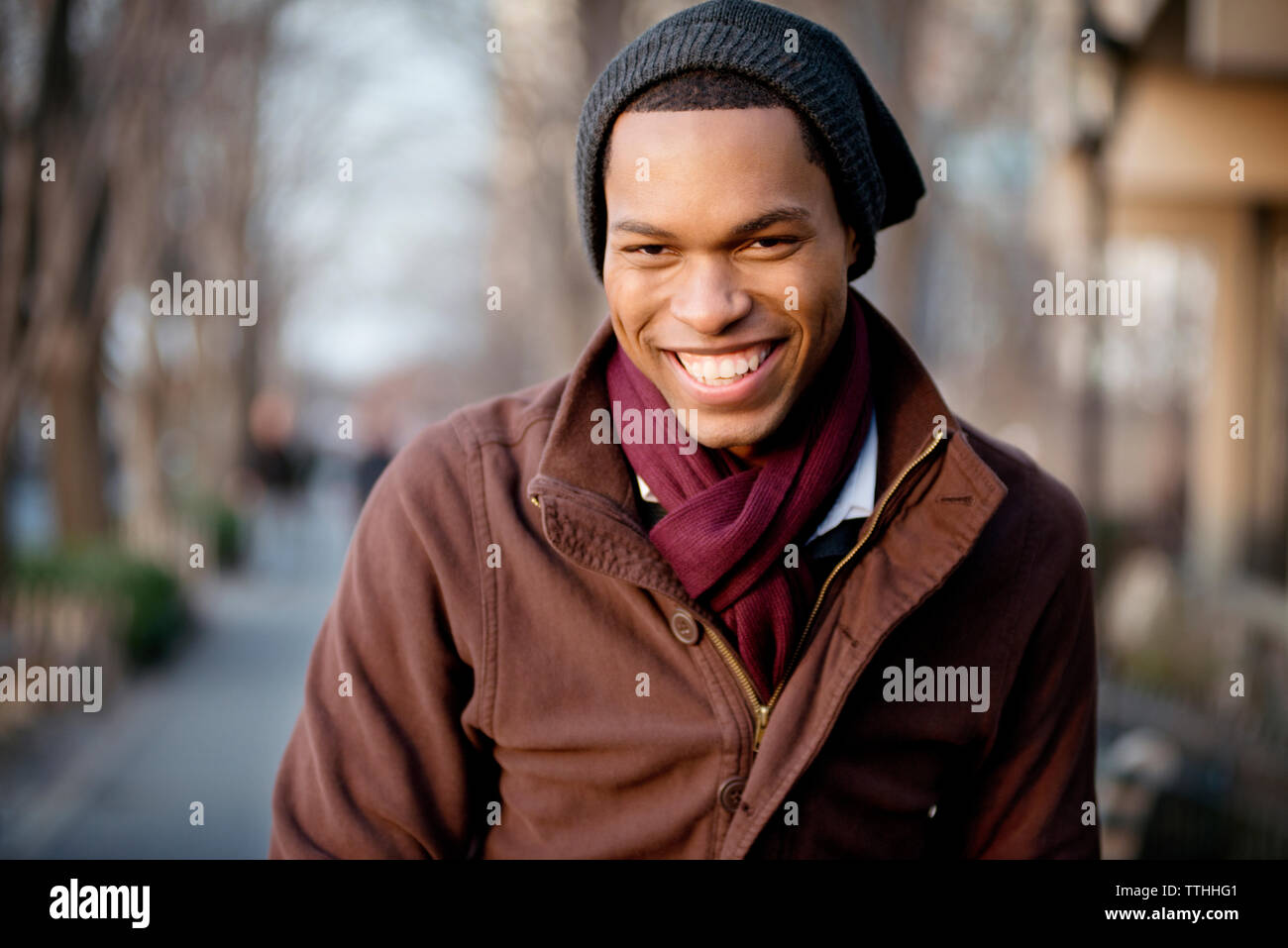 Portrait of cheerful young man wearing knit hat Stock Photo