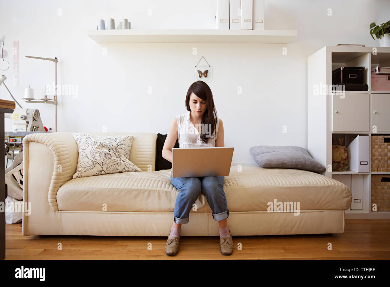 Using laptop sitting sofa at home hi-res stock photography and images ...