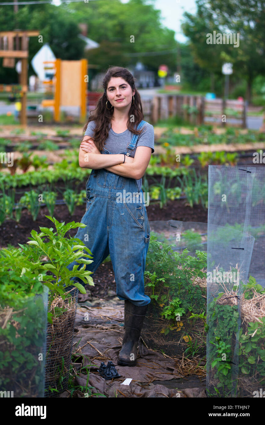 Portrait of confident woman with arms crossed standing at farm Stock ...