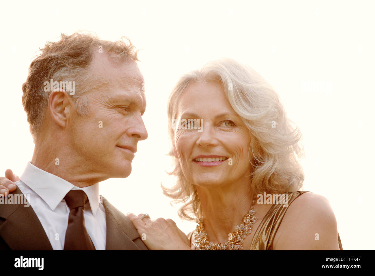 Close-up of senior man looking at beautiful wife against clear sky Stock Photo