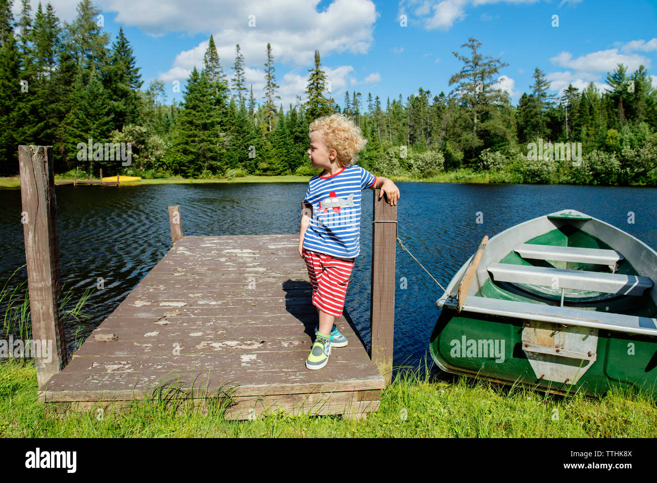 Boy standing on moored boat hi-res stock photography and images - Alamy