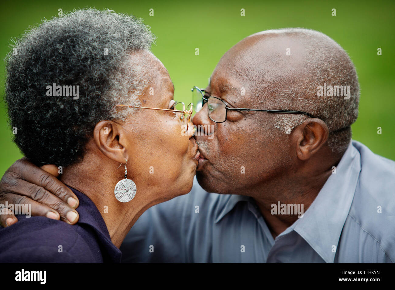 Close-up of senior couple kissing in backyard Stock Photo
