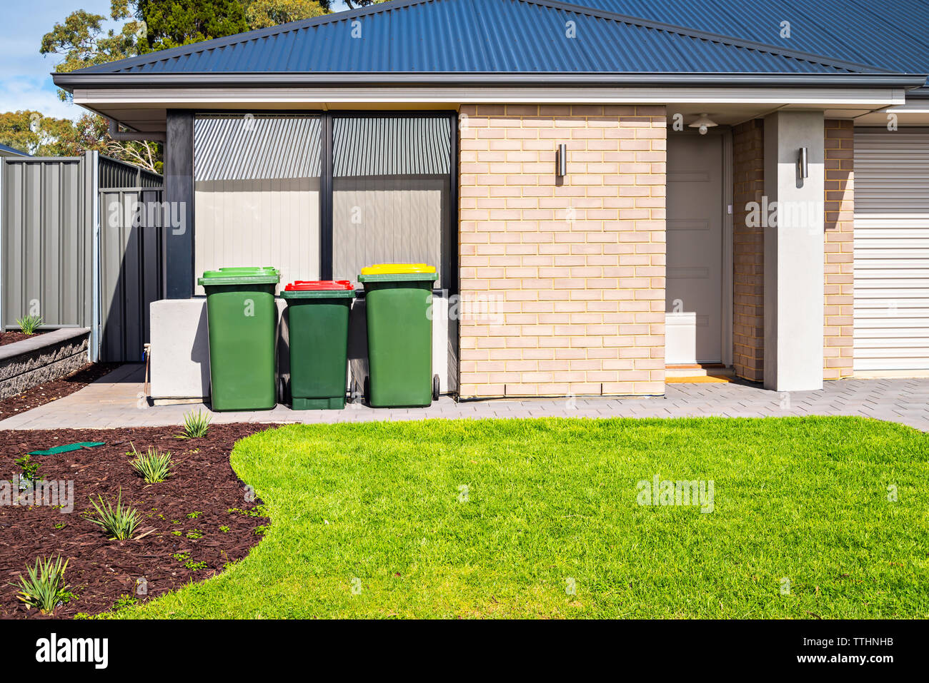 Brand new Australian suburban house with waste bins at the front yard Stock  Photo - Alamy