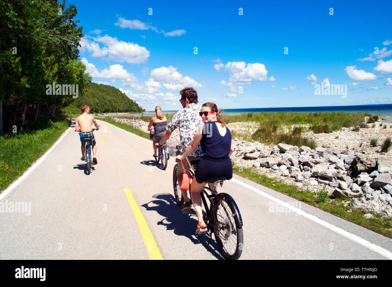 Friends Riding Bicicle Four friends on bicycle trip hi-res stock photography and images - Alamy