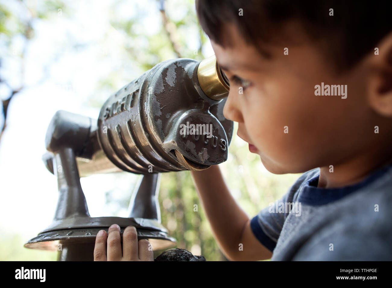 Close-up of boy looking through telescope Stock Photo - Alamy