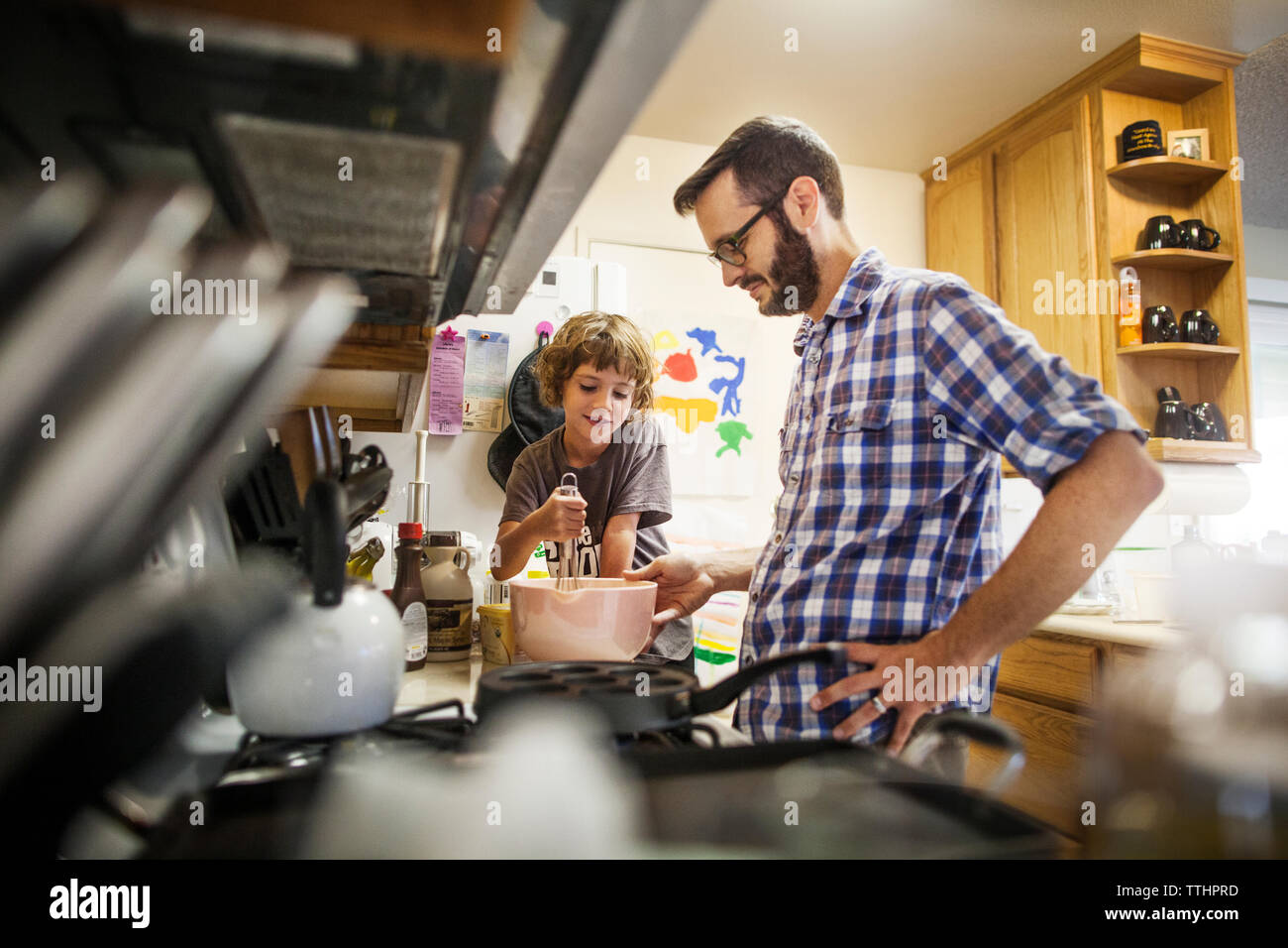 Father and daughter baking food at home Stock Photo