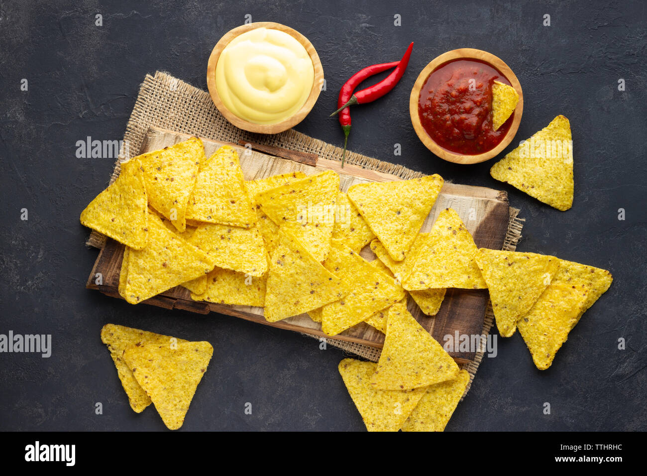 Mexican corn chips nachos with sauces on dark background. Top view Stock Photo Alamy