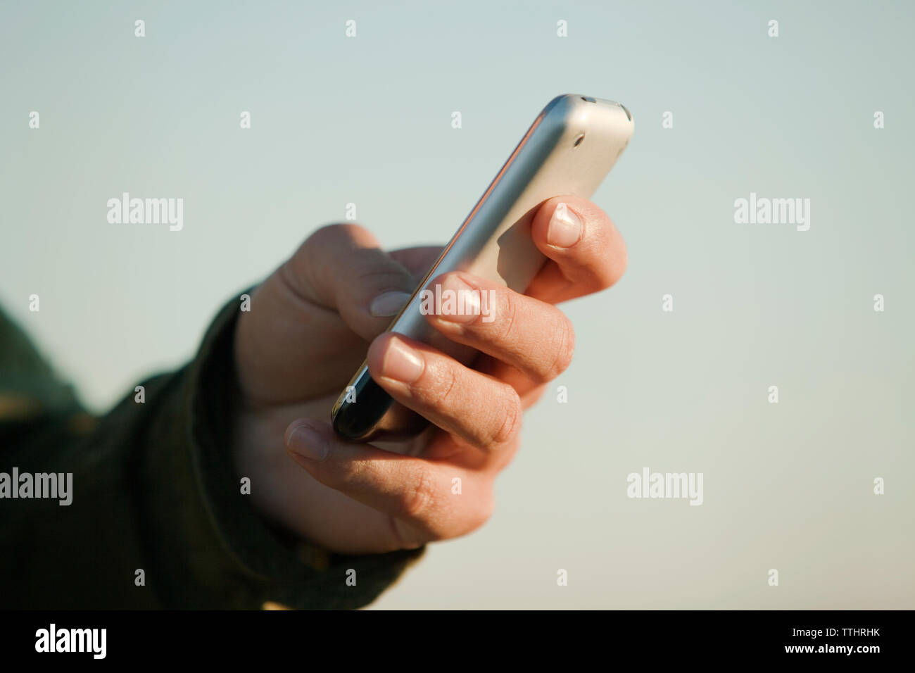 Cropped image of man using mobile phone Stock Photo