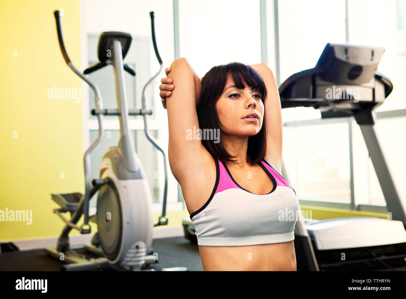 Woman practicing relaxation exercise in gym Stock Photo