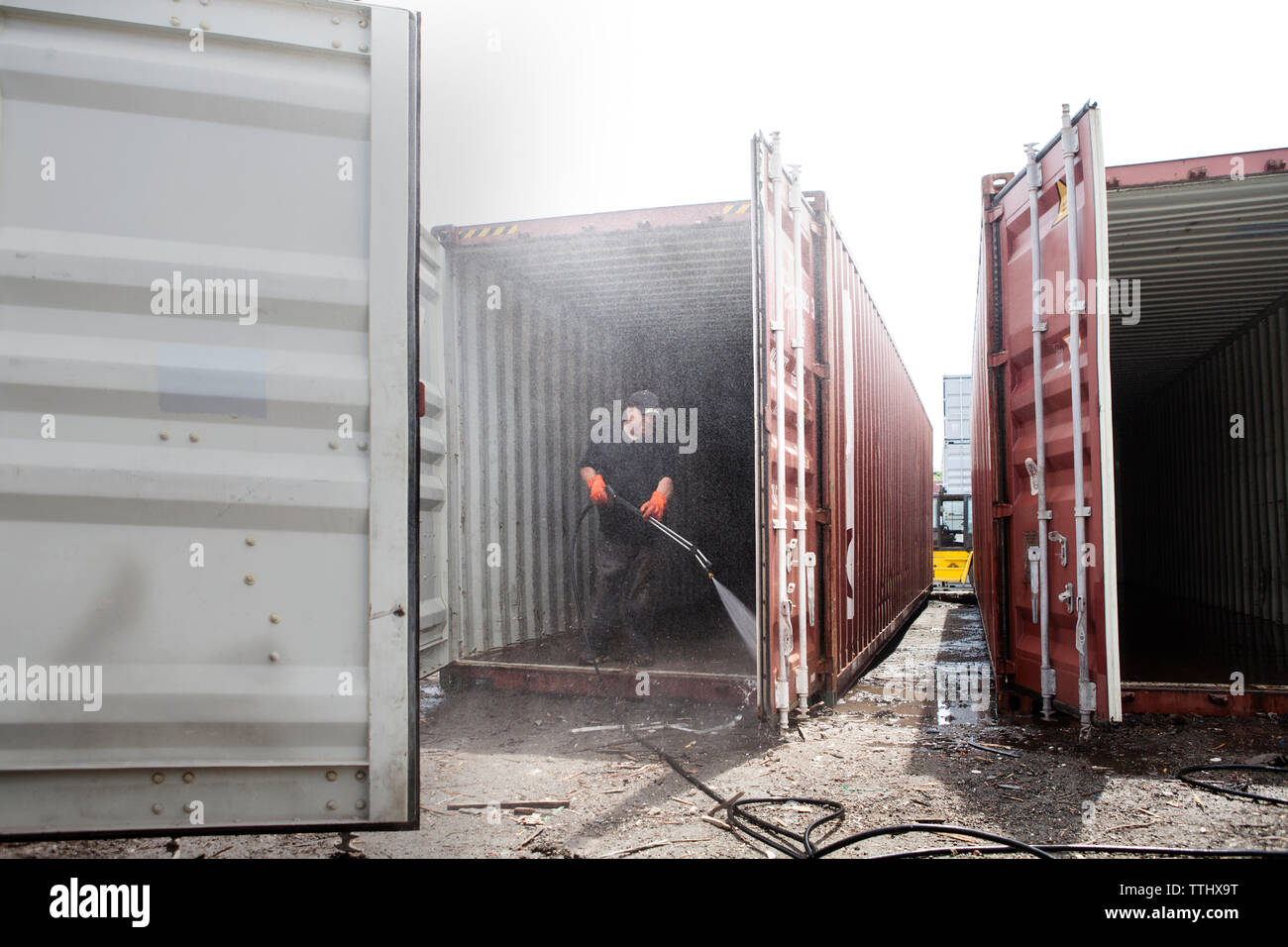 Full length of men cleaning cargo container Stock Photo Alamy