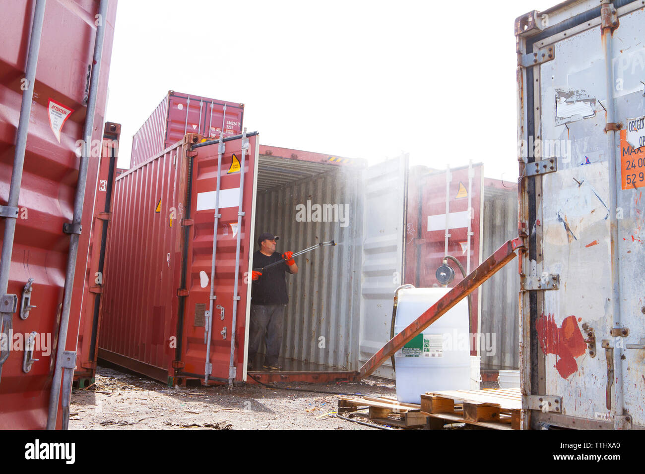 Worker cleaning cargo container at commercial dock Stock Photo Alamy