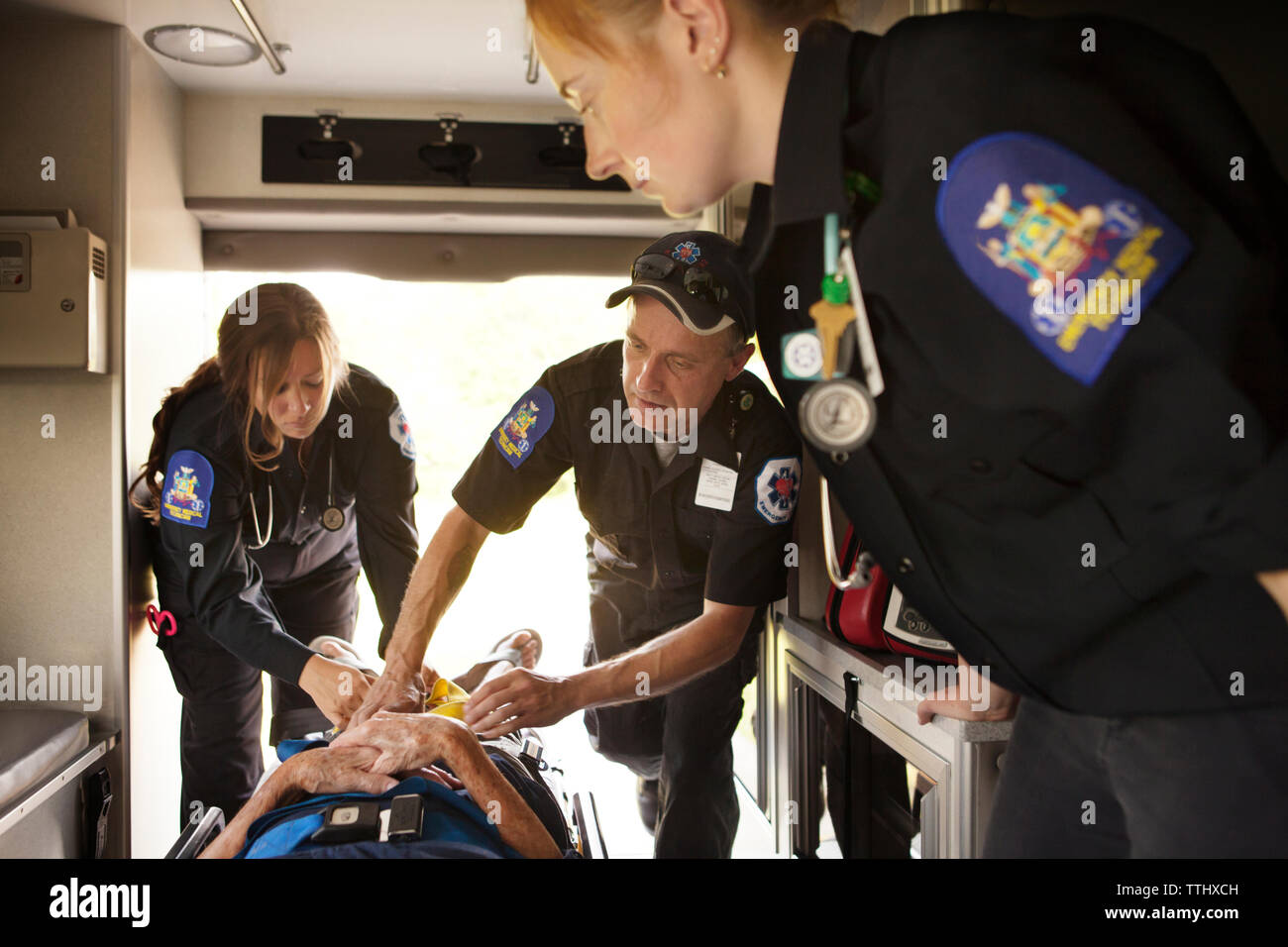 Rescue team providing treatment to patient in ambulance Stock Photo