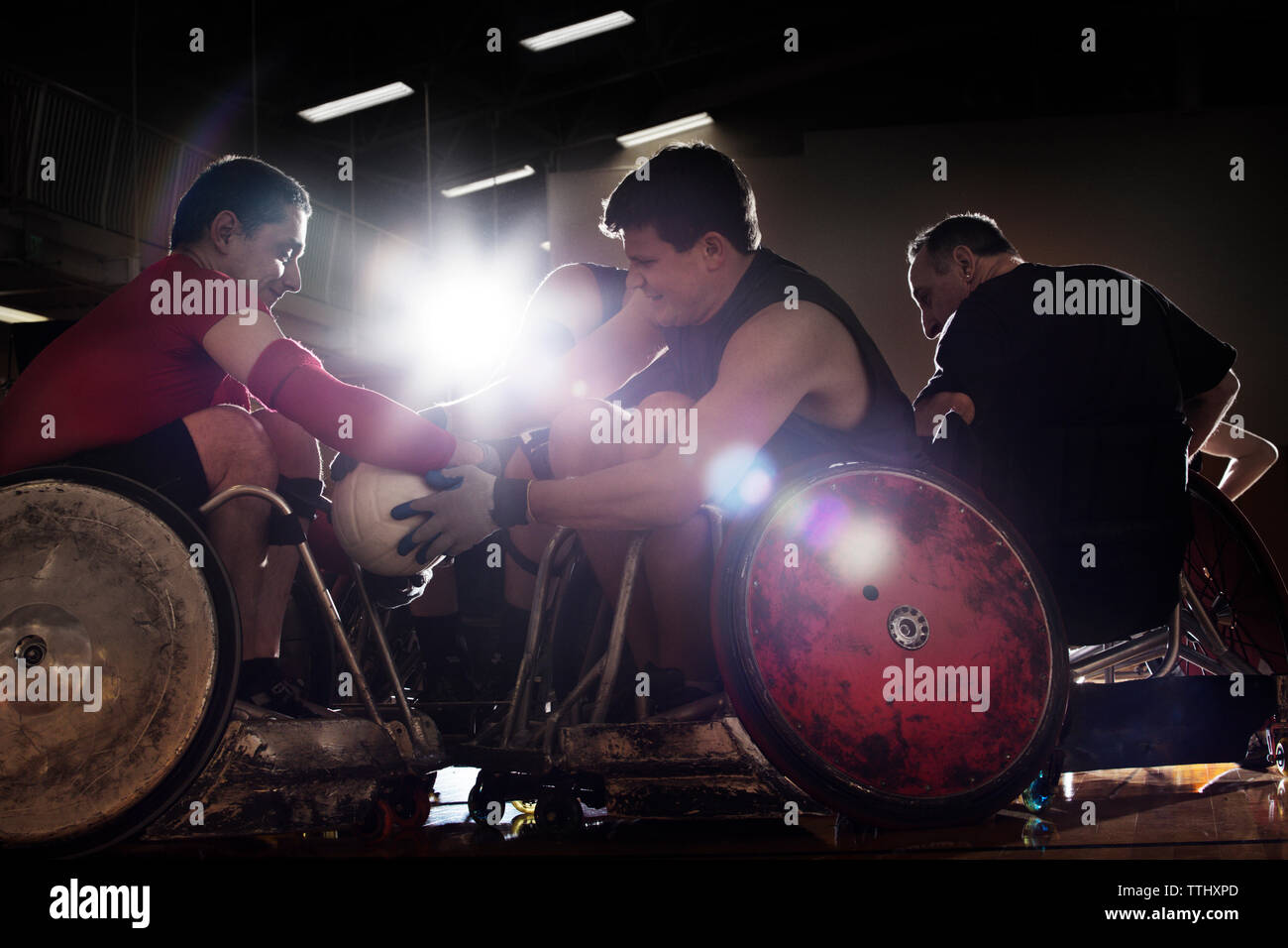 Male athletes playing wheelchair rugby in court Stock Photo Alamy
