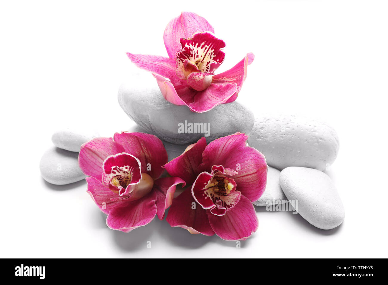 White spa stones and red orchid isolated on white Stock Photo - Alamy
