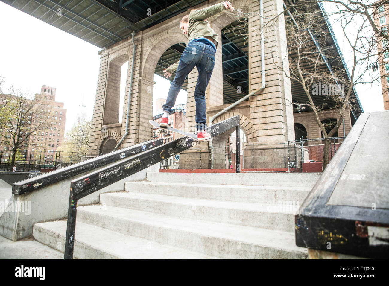 Man skateboarding on railing at steps Stock Photo - Alamy