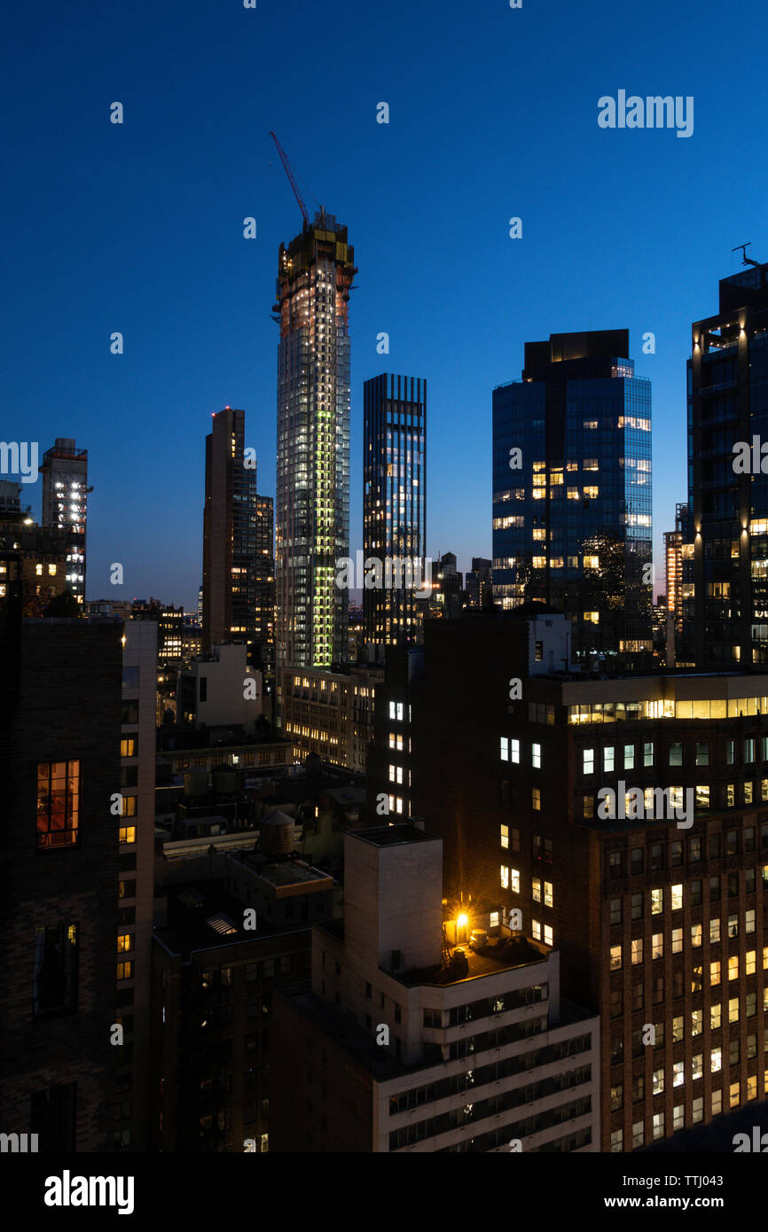 High-rise building construction at night in New York City, USA Stock Photo