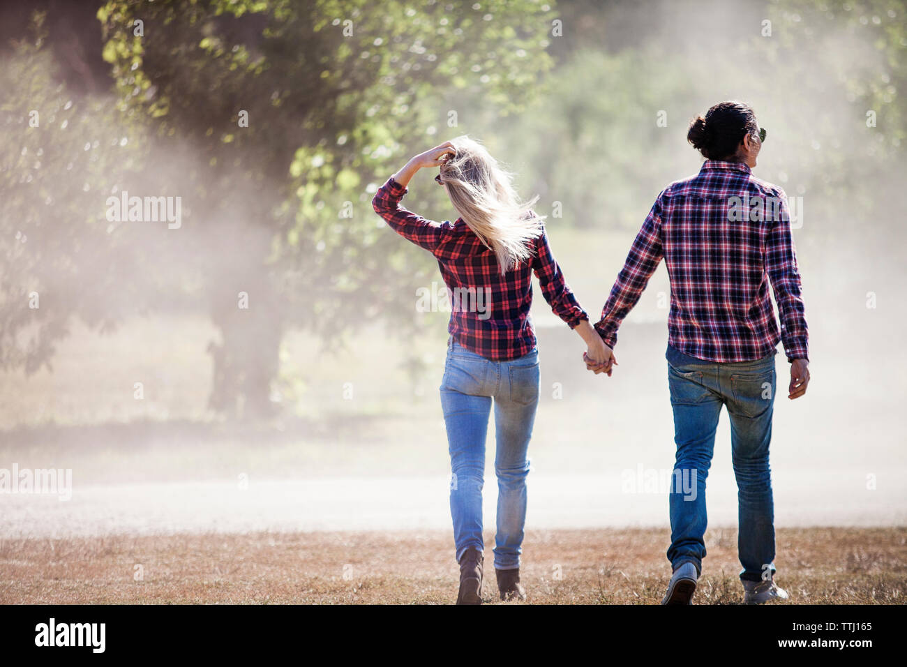 Couple walking holding hands hi-res stock photography and images - Alamy