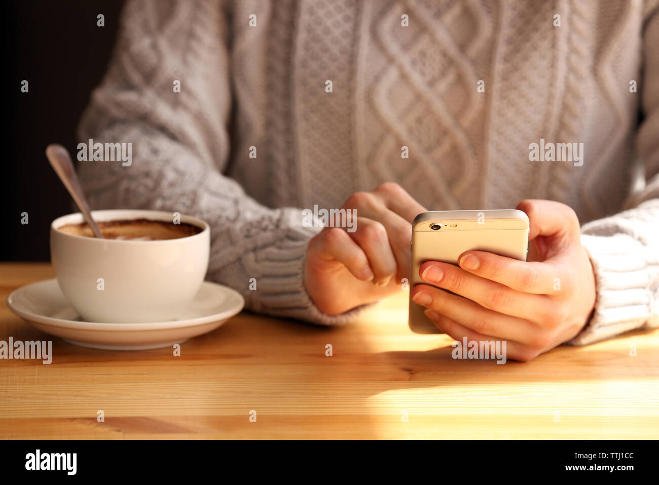 Young woman sitting in cafe Stock Photo - Alamy
