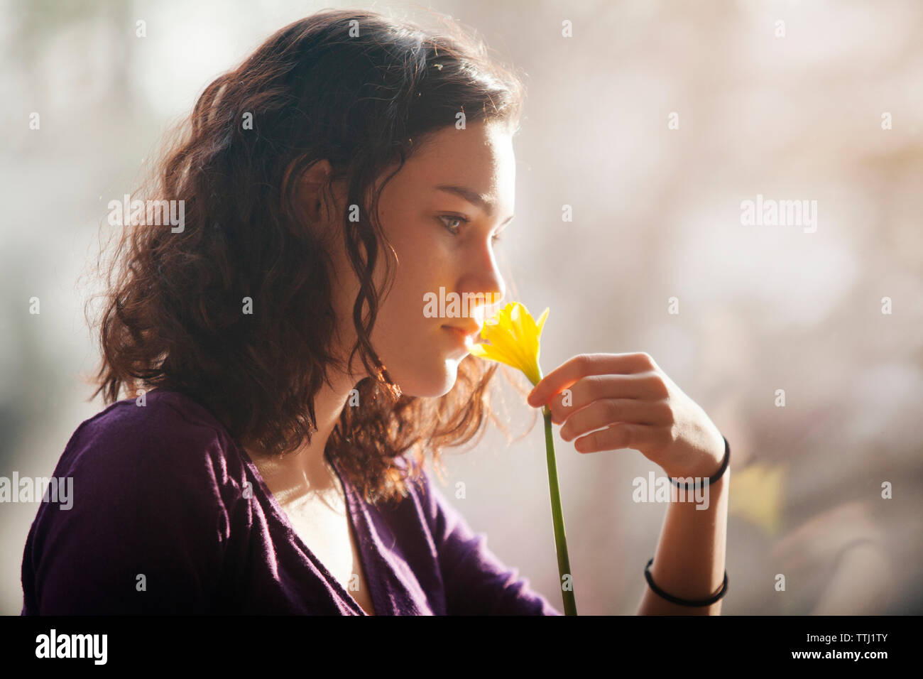 Teenage girl smelling flower Stock Photo