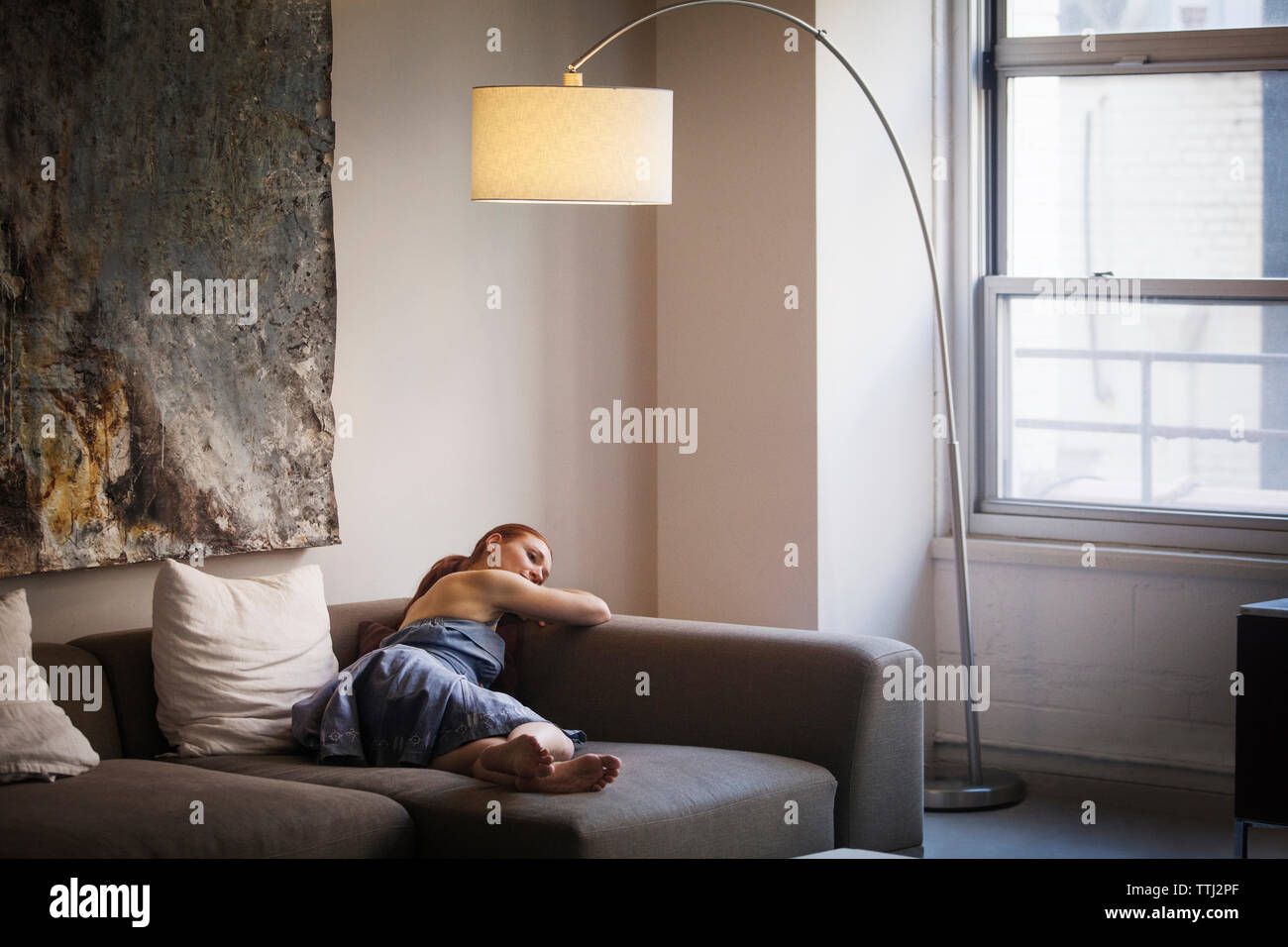 Woman relaxing sofa hi-res stock photography and images - Alamy