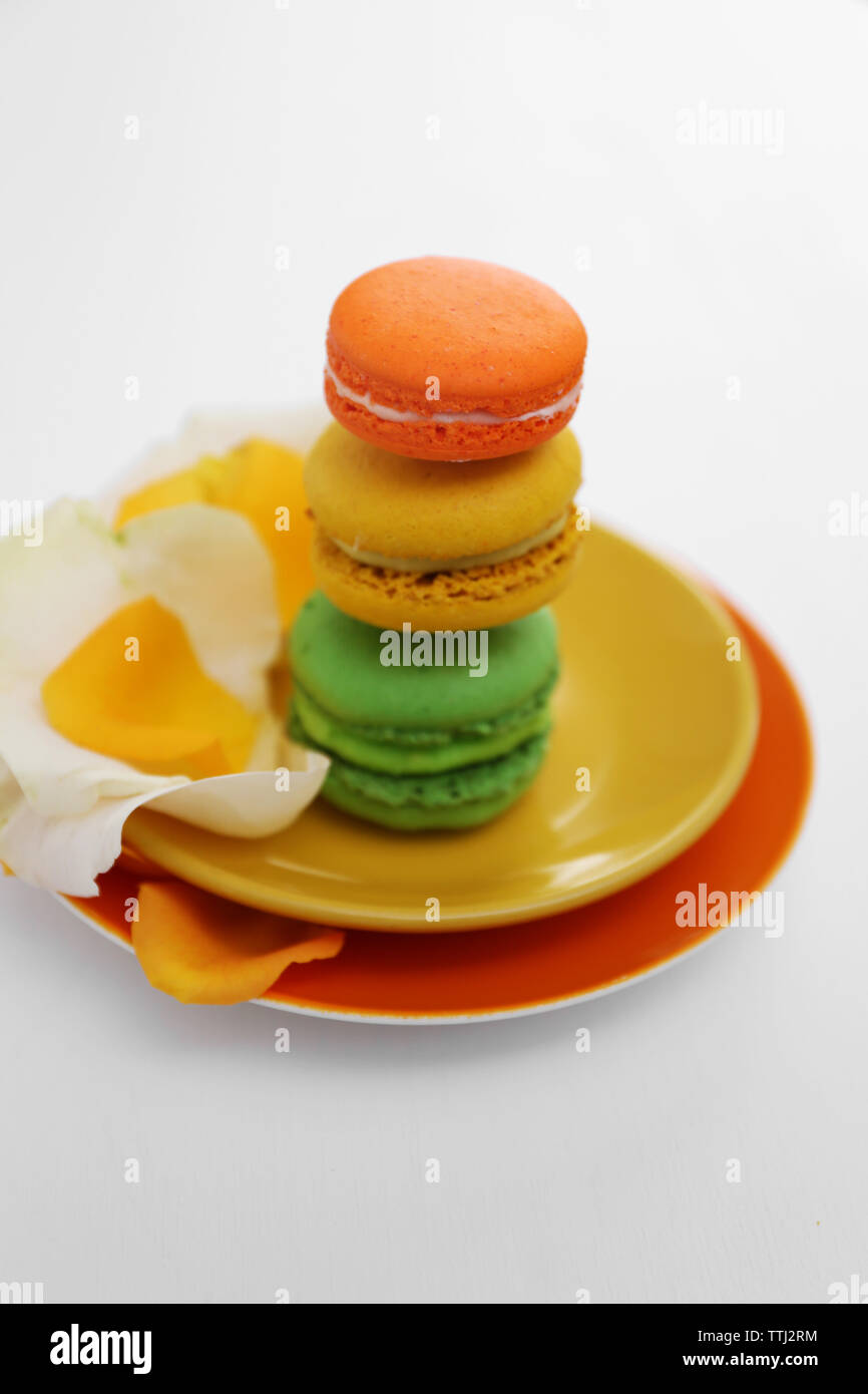 Plate with colorful macaroons on white background Stock Photo
