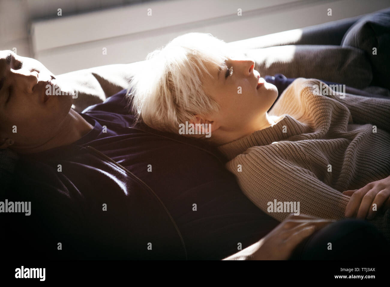 African couple sleeping on sofa hi-res stock photography and images - Alamy