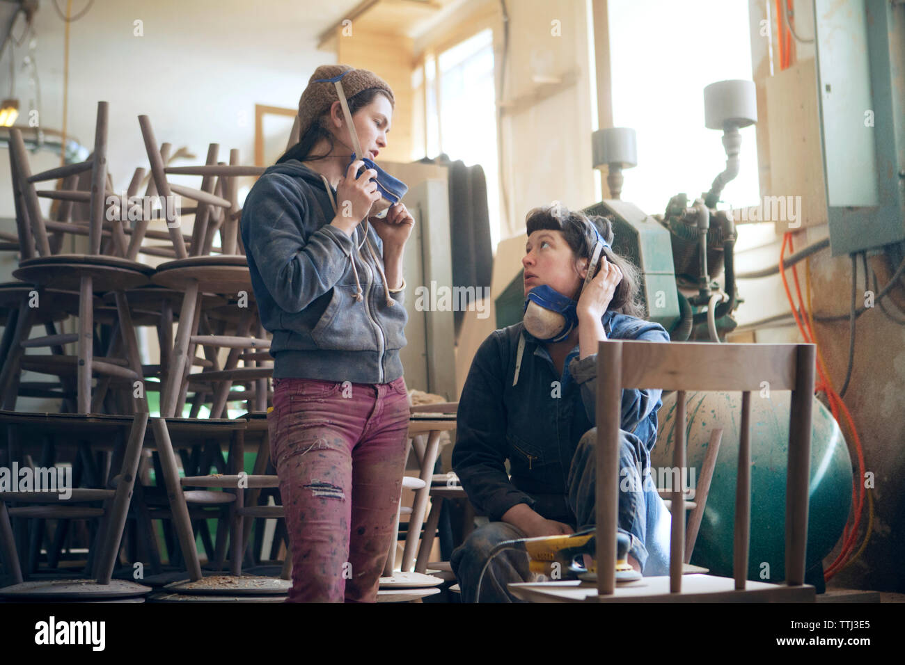 Female carpenters discussing in workshop Stock Photo