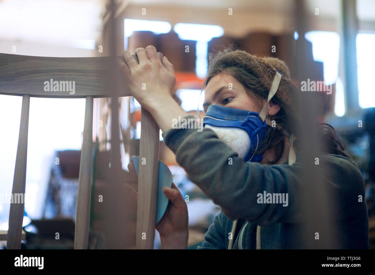 Carpenter rubbing paper on wooden chair at Stock Photo Alamy