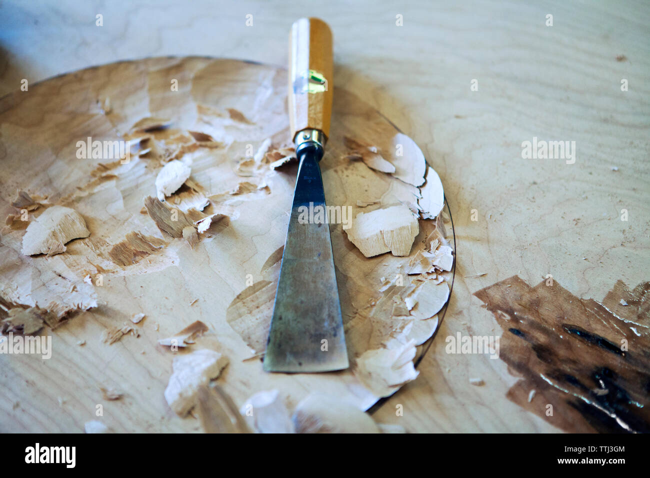 High angle view of chisel on wooden table at workshop Stock Photo