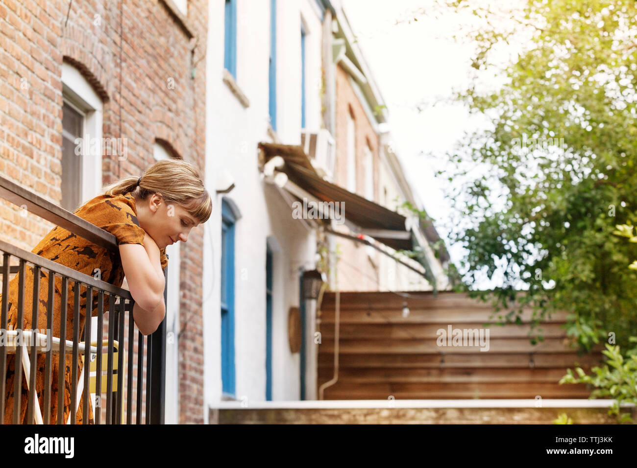 Leaning on balcony hi-res stock photography and images - Alamy