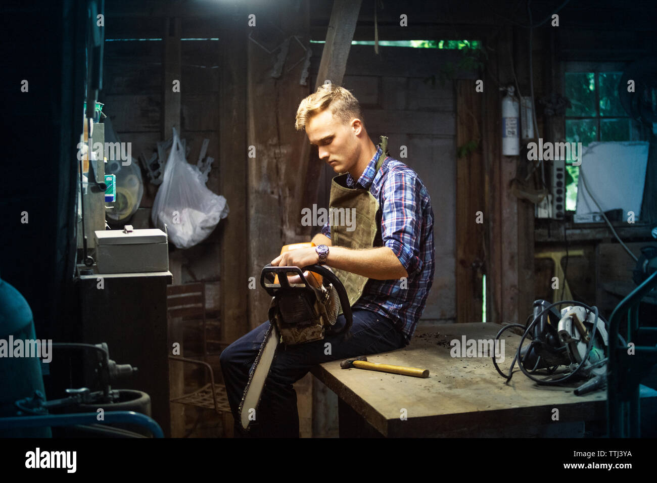 Man holding chainsaw hi-res stock photography and images - Alamy