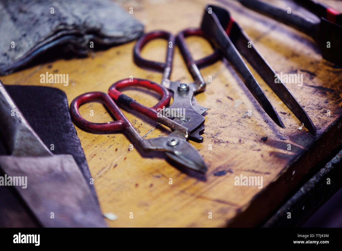 Scissors and tweezers on workbench at workshop Stock Photo