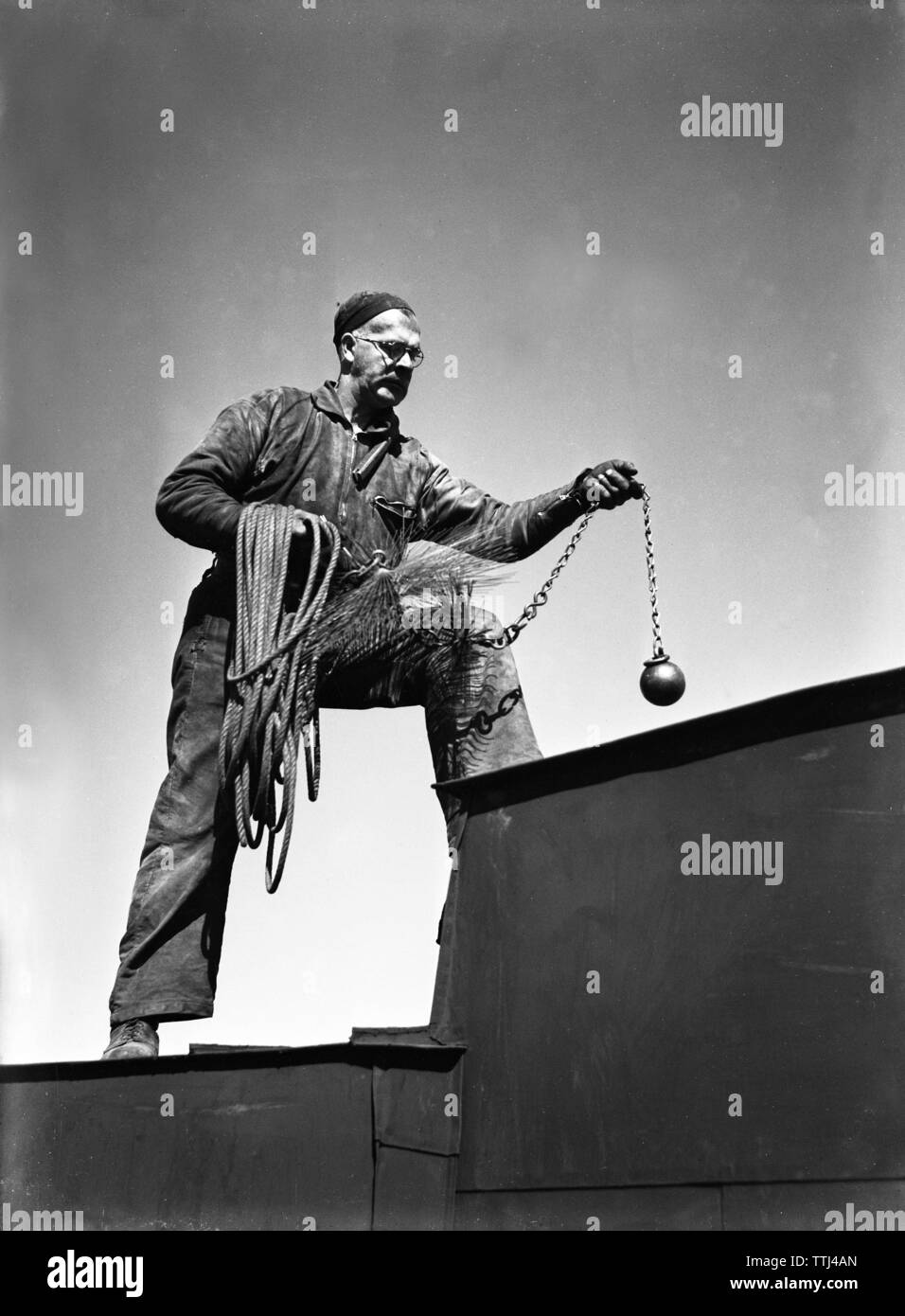 Chimney sweep. A man works as chimney sweeper and climbing the roof all  dressed for work and carrying his equipment. Sweden 1940. Kristoffersson  ref 120-2 Stock Photo - Alamy