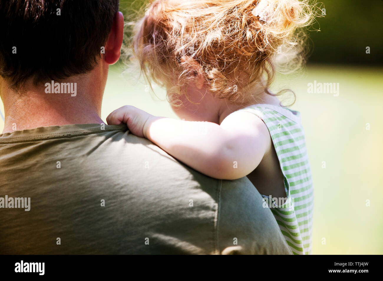 Close-up of father carrying daughter at park Stock Photo