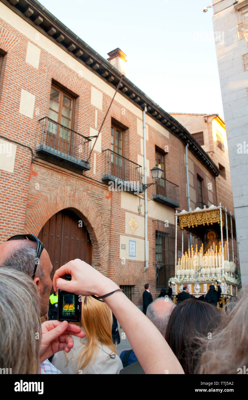 Woman taking photos of a Holy Week procession. Madrid, Spain. Stock Photo