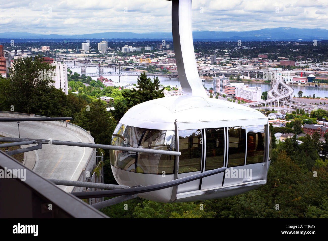 Overhead cable car against cityscape Stock Photo