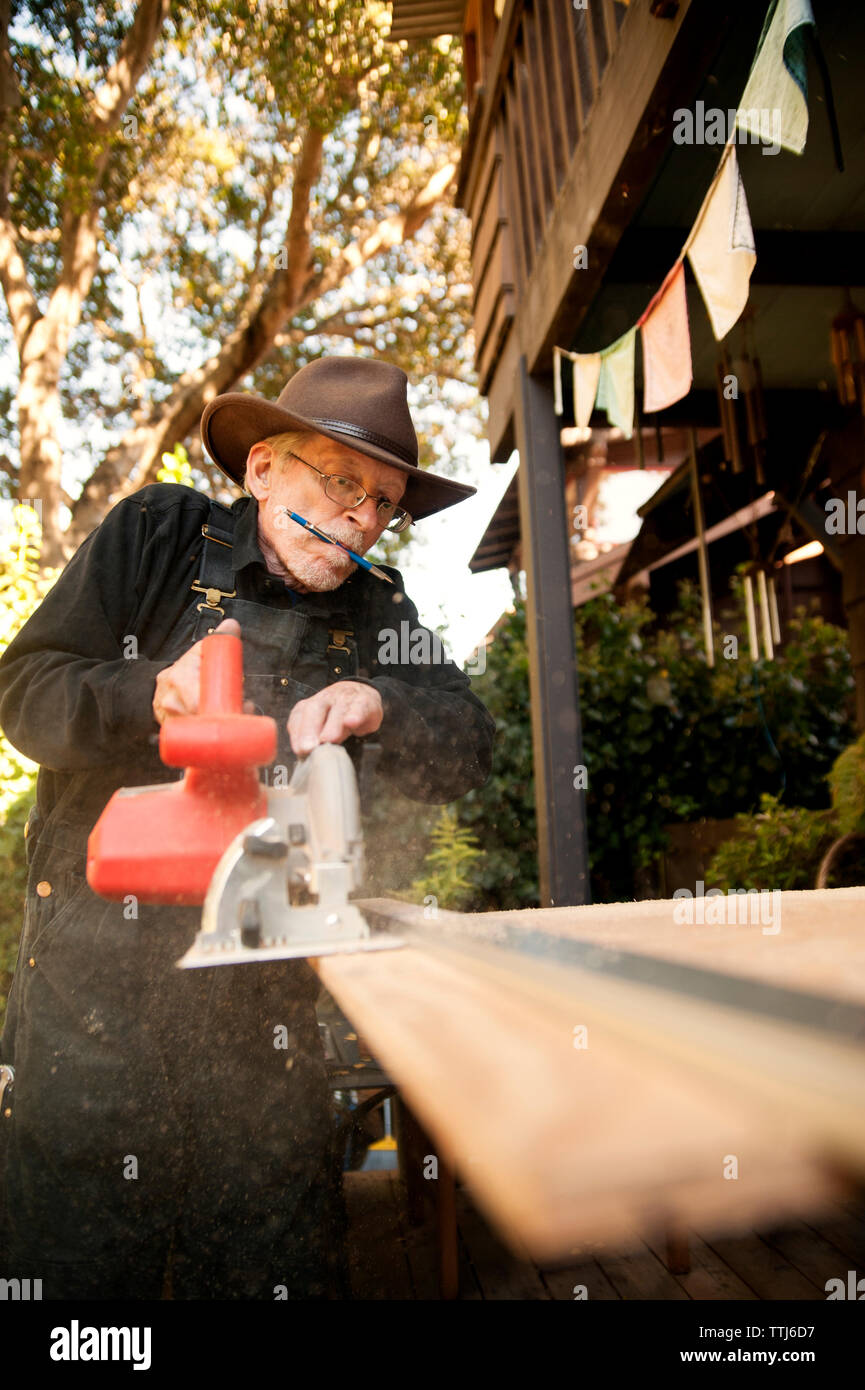 Carpenter using circular saw at workshop Stock Photo