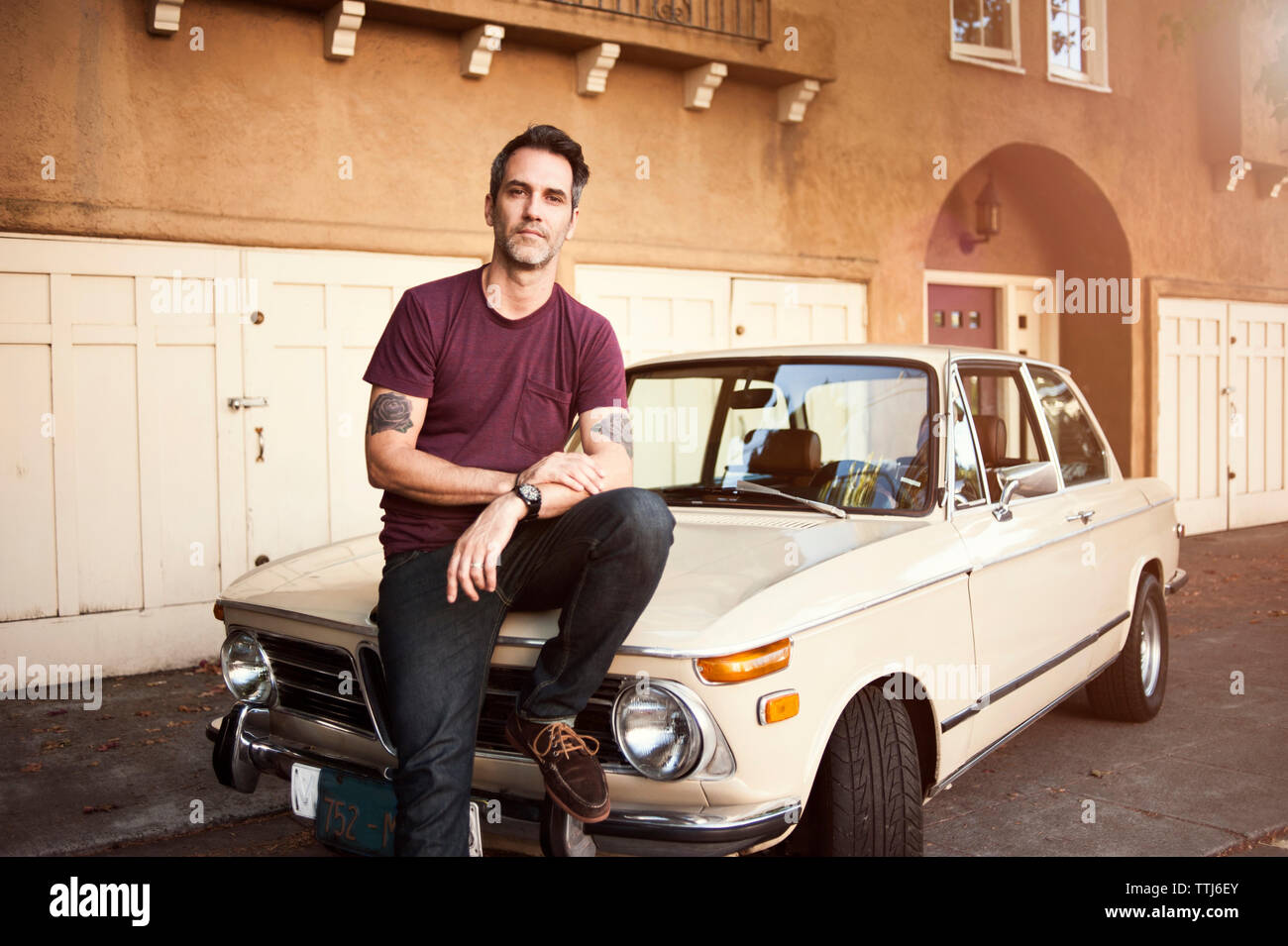 Portrait of man standing by car Stock Photo