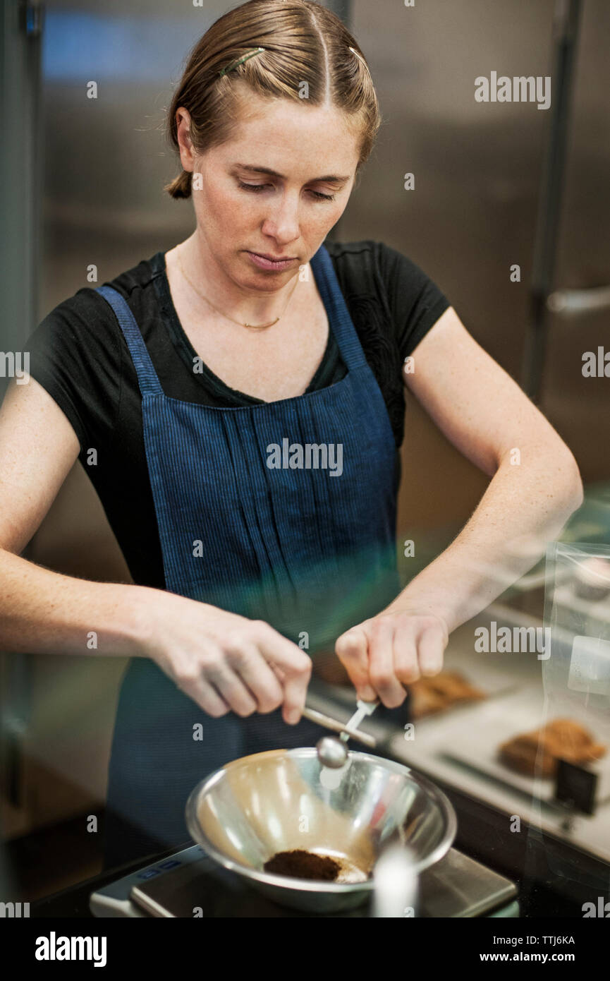 Woman preparing food in commercial kitchen Stock Photo