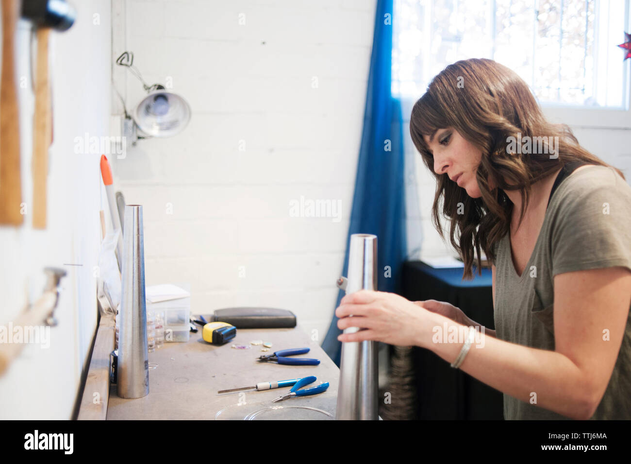 Woman working in workshop Stock Photo