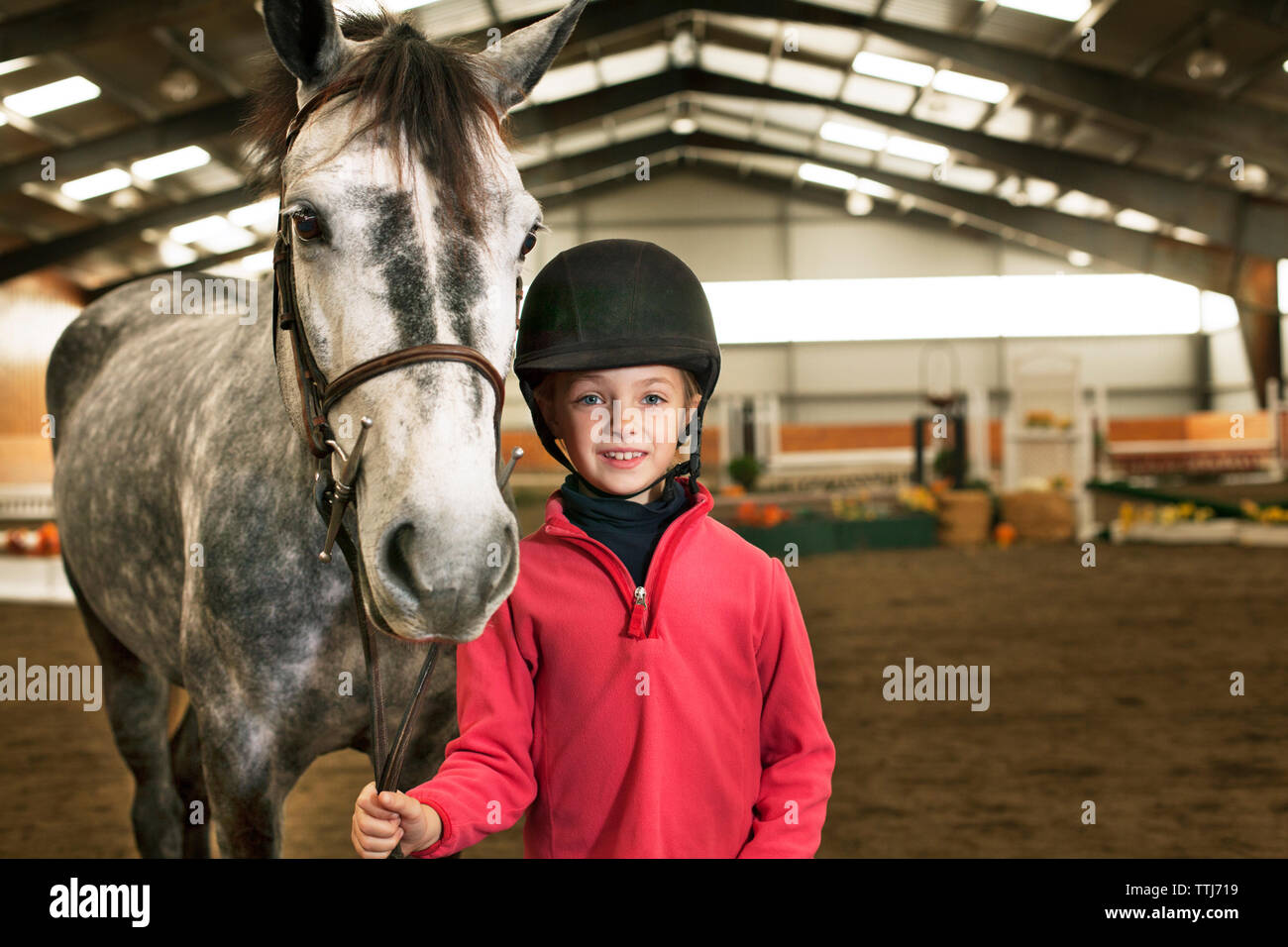 Portrait of boy with horse standing in stable Stock Photo