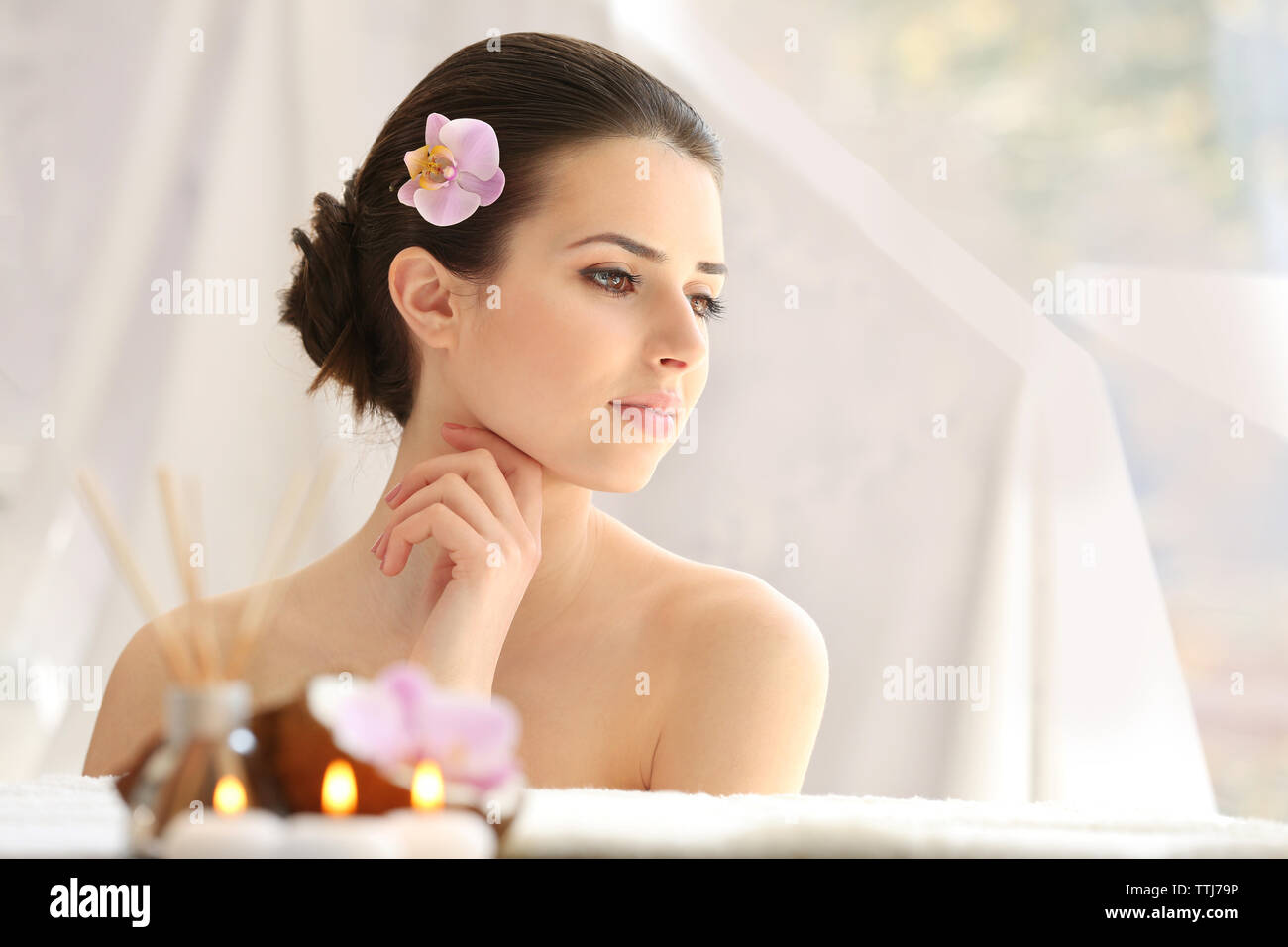 Young woman with flower relaxing in spa center Stock Photo - Alamy
