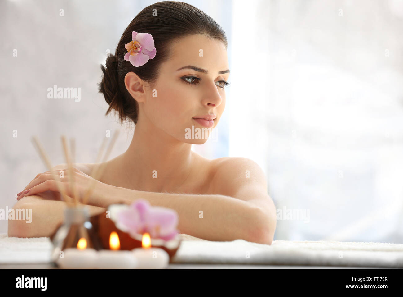 Young woman with flower relaxing in spa center Stock Photo - Alamy